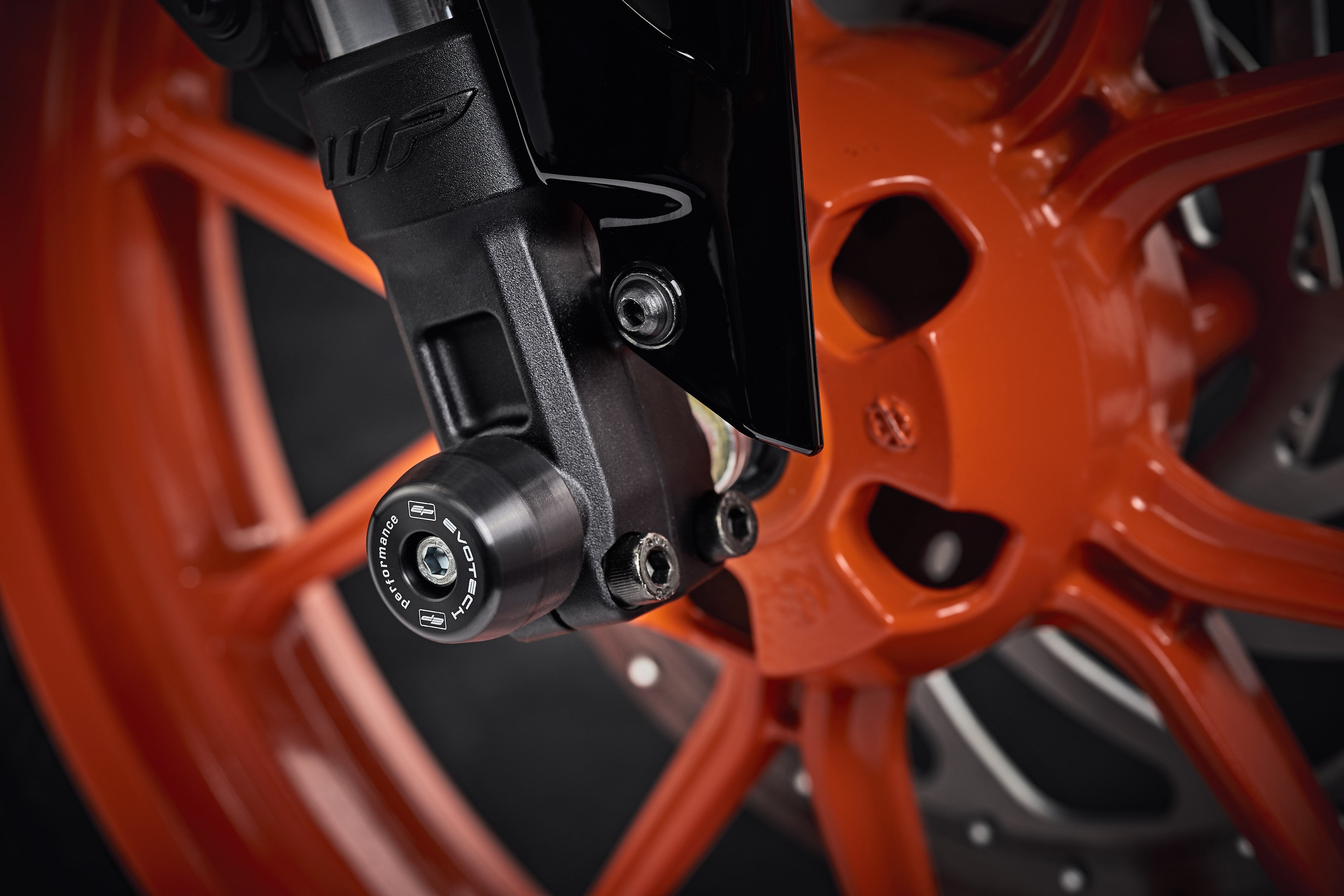 The lower front fork of the KTM 125 Duke with EP Front Spindle Bobbins securely attached, offering crash protection to the motorcycleâs front wheel.